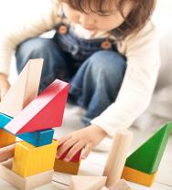 Child building a tower of colourful blocks